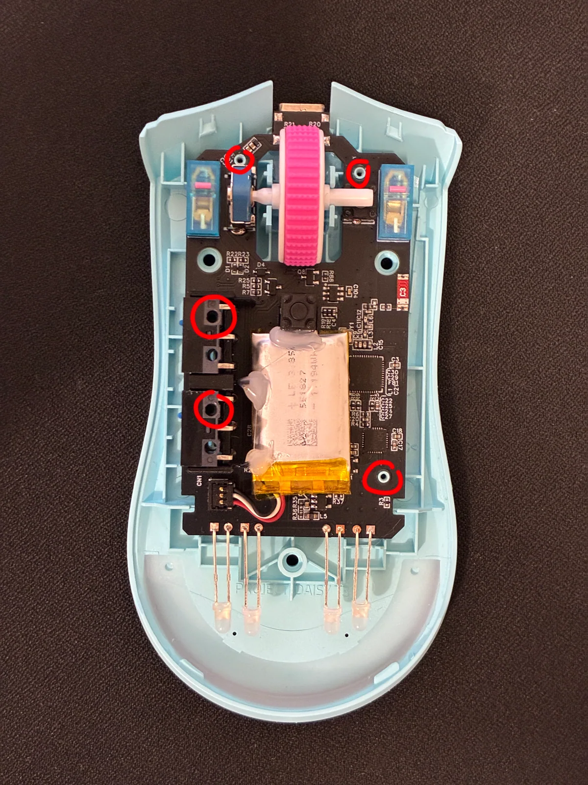 Five red-circled mounting holes on the PCB
