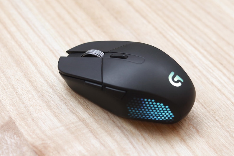 Black wireless Logitech G302 conversion on a light wood surface